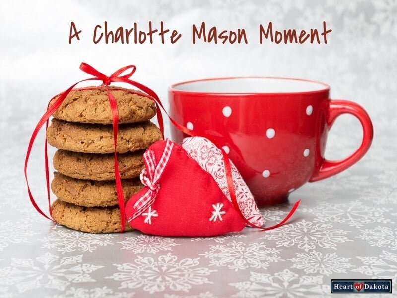 Heart of Dakota Charlotte Mason Moment title photo - red mug with cookies on a white tablecloth