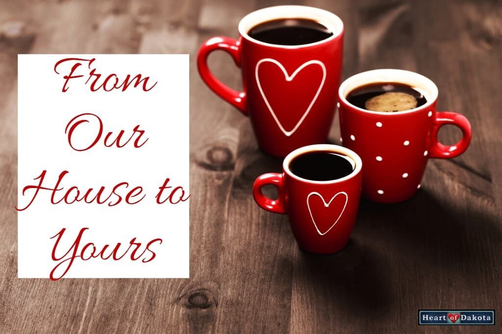From Our House to Yours - three red ceramic mugs with coffee sitting on a wooden table